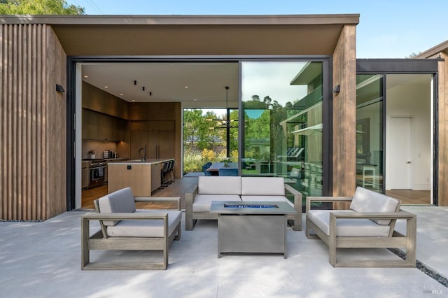 view of patio with outdoor lounge area and a sink