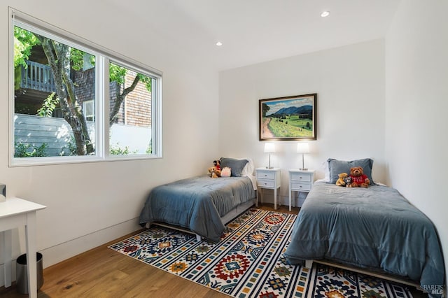 bedroom featuring recessed lighting and wood finished floors