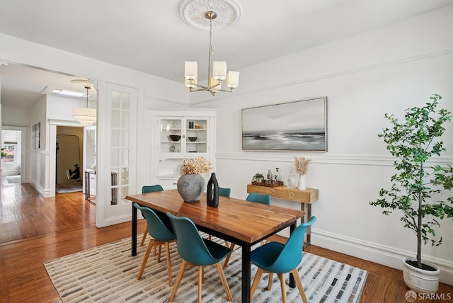 1483 Guerrero St, San Francisco, CA 94110 - dining room featuring a chandelier, wood finished floors, and a decorative wall