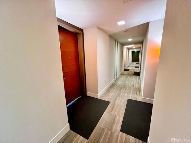 corridor featuring light hardwood / wood-style floors