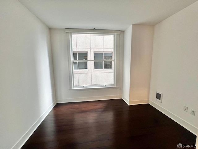 empty room with dark wood-type flooring