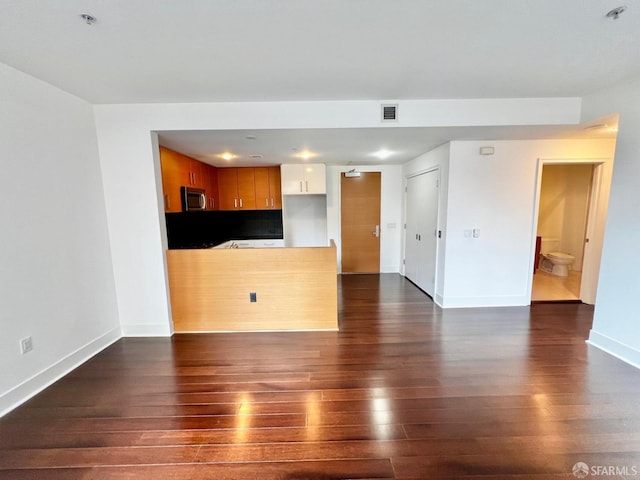 unfurnished living room with dark hardwood / wood-style flooring