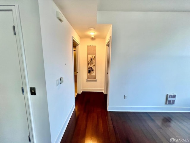 corridor featuring dark hardwood / wood-style floors