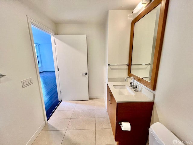 bathroom featuring vanity, tile patterned floors, and toilet