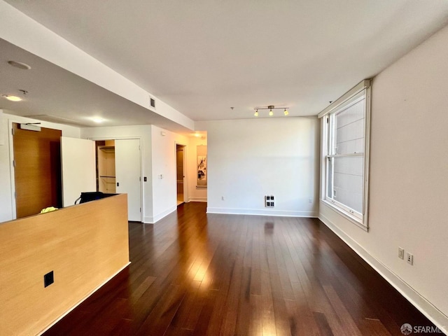 unfurnished living room with dark hardwood / wood-style flooring