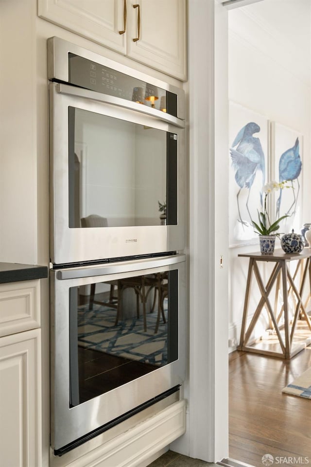 details featuring dark countertops and double oven