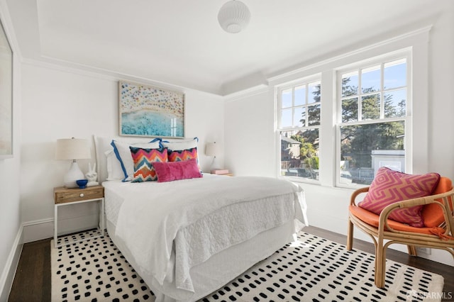 bedroom featuring wood finished floors and baseboards