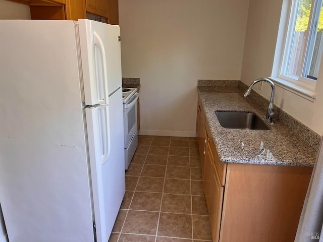 1080 Tijuana Ct, Santa Rosa, CA 95401 - kitchen with brown cabinets, tile patterned floors, a sink, and white appliances