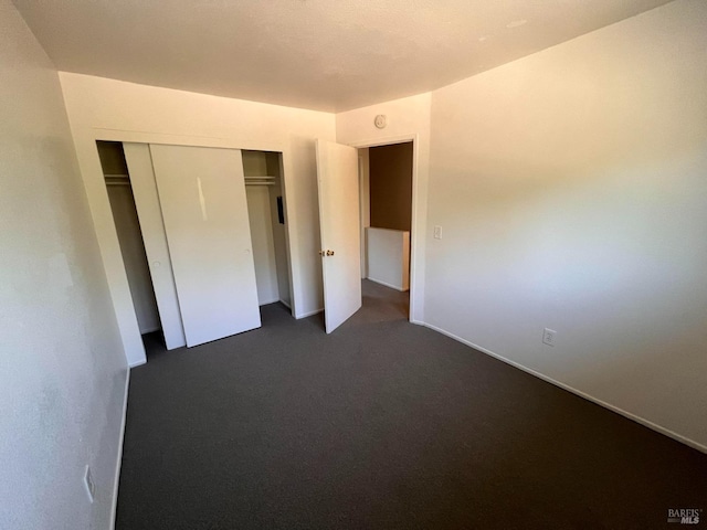 1080 Tijuana Ct, Santa Rosa, CA 95401 - unfurnished bedroom featuring baseboards, dark carpet, and a closet