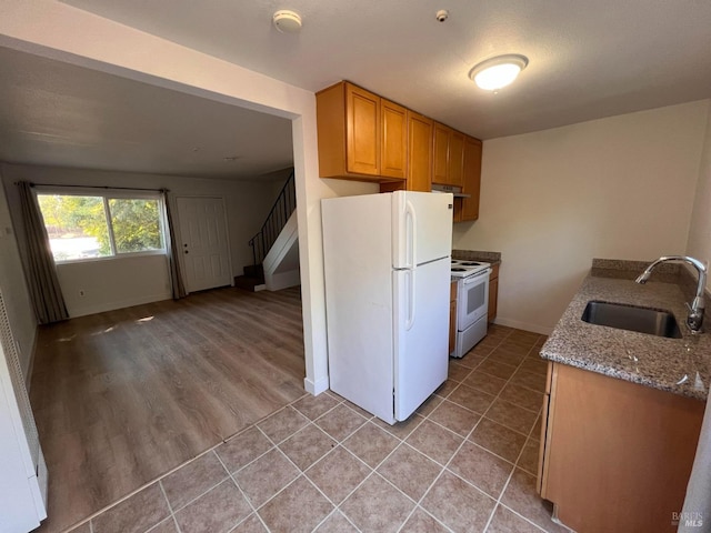 1080 Tijuana Ct, Santa Rosa, CA 95401 - kitchen with a sink, white appliances, light tile patterned floors, stone countertops, and baseboards