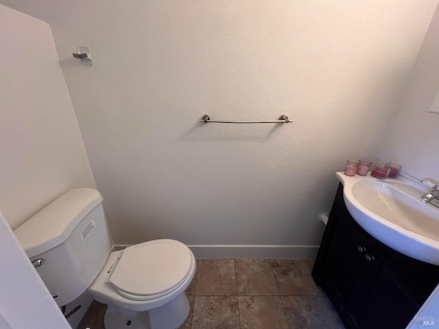 1080 Tijuana Ct, Santa Rosa, CA 95401 - bathroom featuring baseboards, toilet, vanity, and tile patterned floors