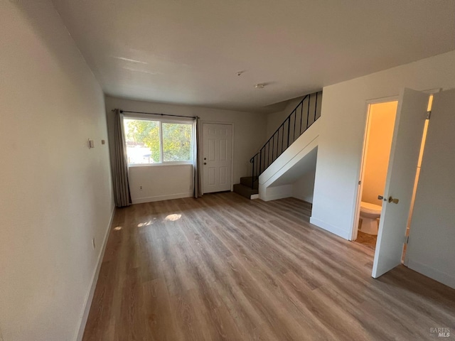 1080 Tijuana Ct, Santa Rosa, CA 95401 - unfurnished living room featuring wood finished floors, baseboards, and stairway