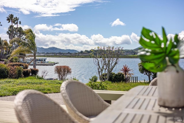 water view featuring a mountain view and a dock