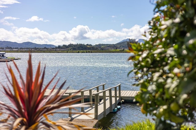 view of dock featuring a water and mountain view