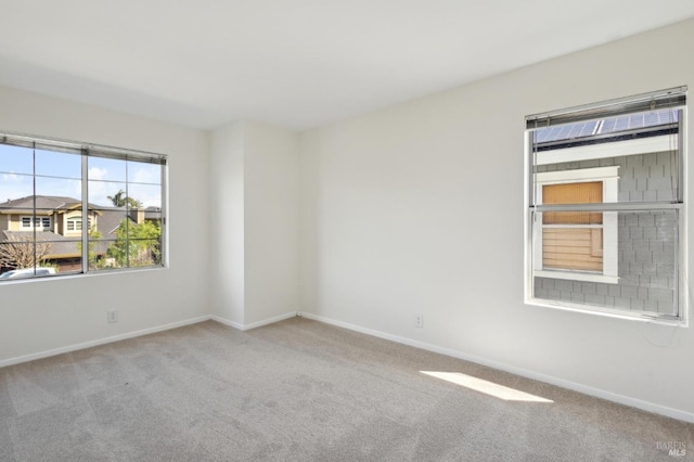 spare room with carpet flooring and baseboards