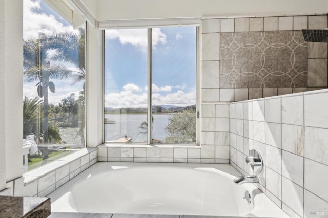 bathroom with a bath and a water view