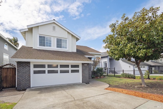 traditional-style house featuring brick siding, an attached garage, concrete driveway, and fence