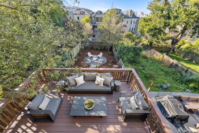 wooden deck featuring an outdoor living space and area for grilling