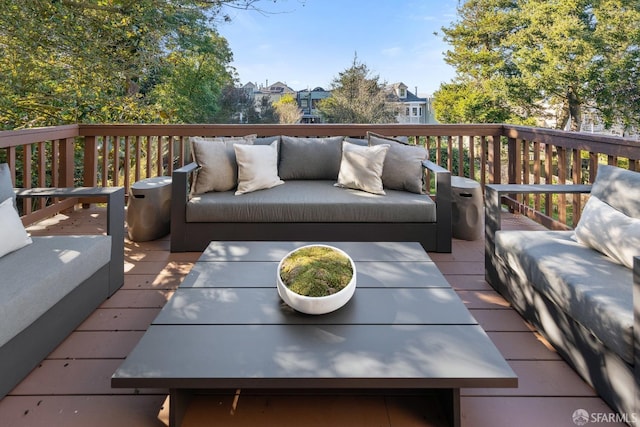 wooden terrace with an outdoor living space