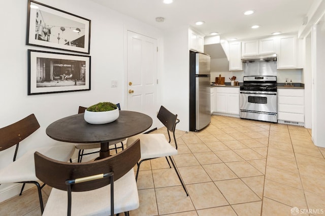 kitchen with white cabinetry, stainless steel appliances, and light tile patterned floors