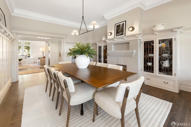 dining room featuring ornamental molding, dark hardwood / wood-style floors, and a chandelier