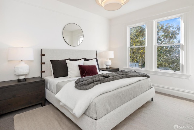 carpeted bedroom featuring multiple windows