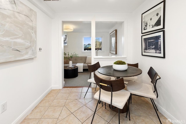 dining space featuring light tile patterned floors