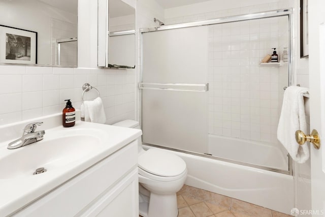 full bathroom featuring tile patterned floors, tasteful backsplash, tile walls, vanity, and enclosed tub / shower combo