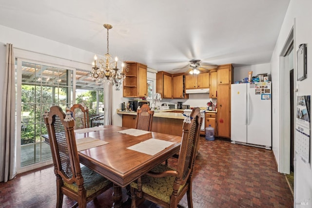 dining area with ceiling fan with notable chandelier and dark wood-type flooring