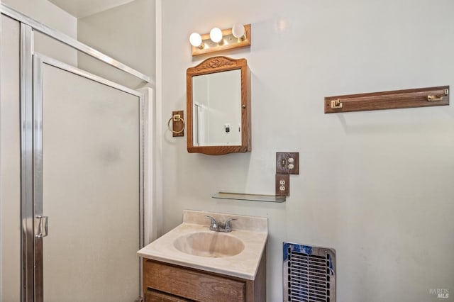 bathroom featuring vanity and an enclosed shower