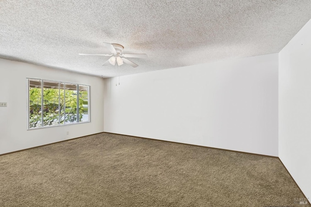 carpeted spare room with ceiling fan and a textured ceiling