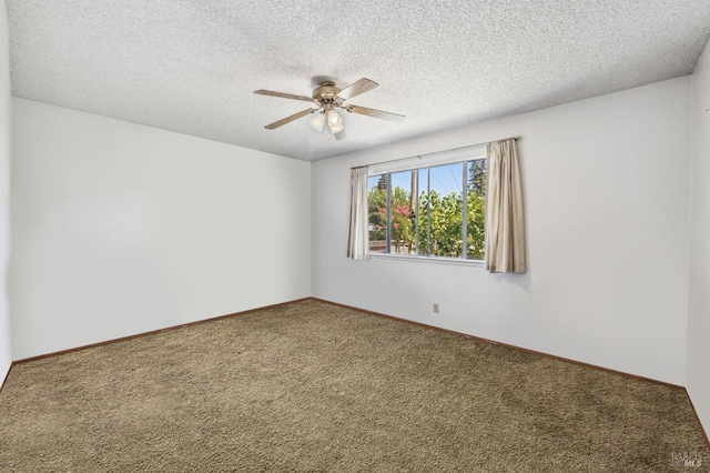 empty room featuring ceiling fan, carpet floors, and a textured ceiling