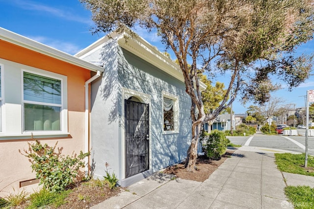 view of side of property with stucco siding