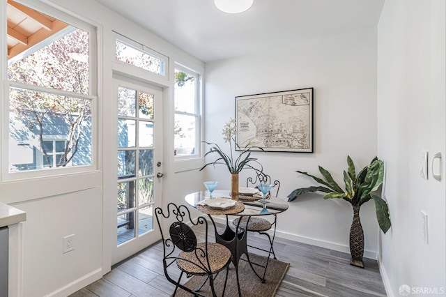 dining room featuring wood finished floors and baseboards