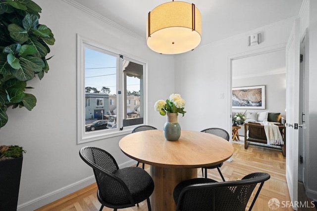 dining room featuring light parquet flooring and ornamental molding