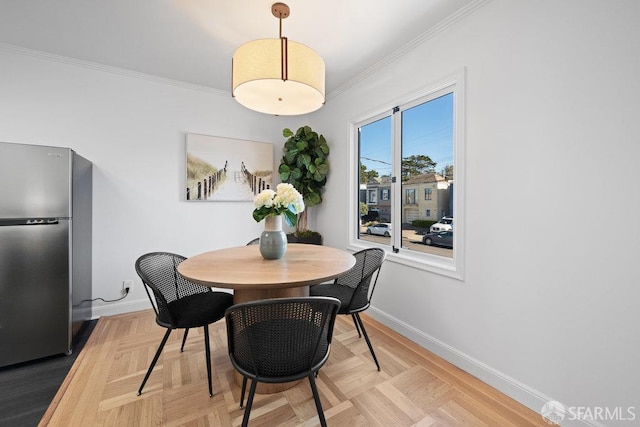 dining space featuring ornamental molding and parquet floors