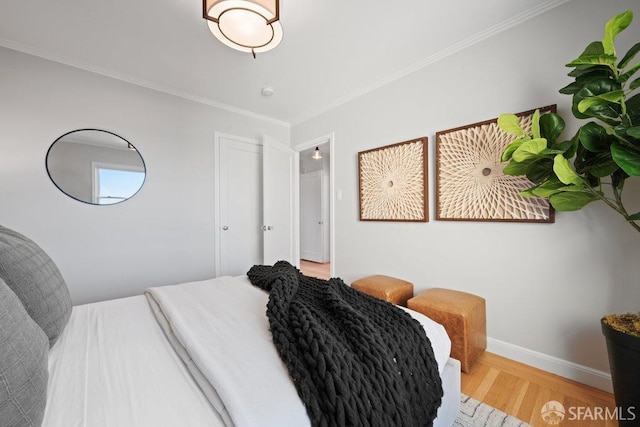 bedroom featuring ornamental molding and hardwood / wood-style floors