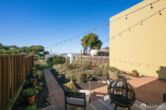 view of patio / terrace featuring an outdoor fire pit