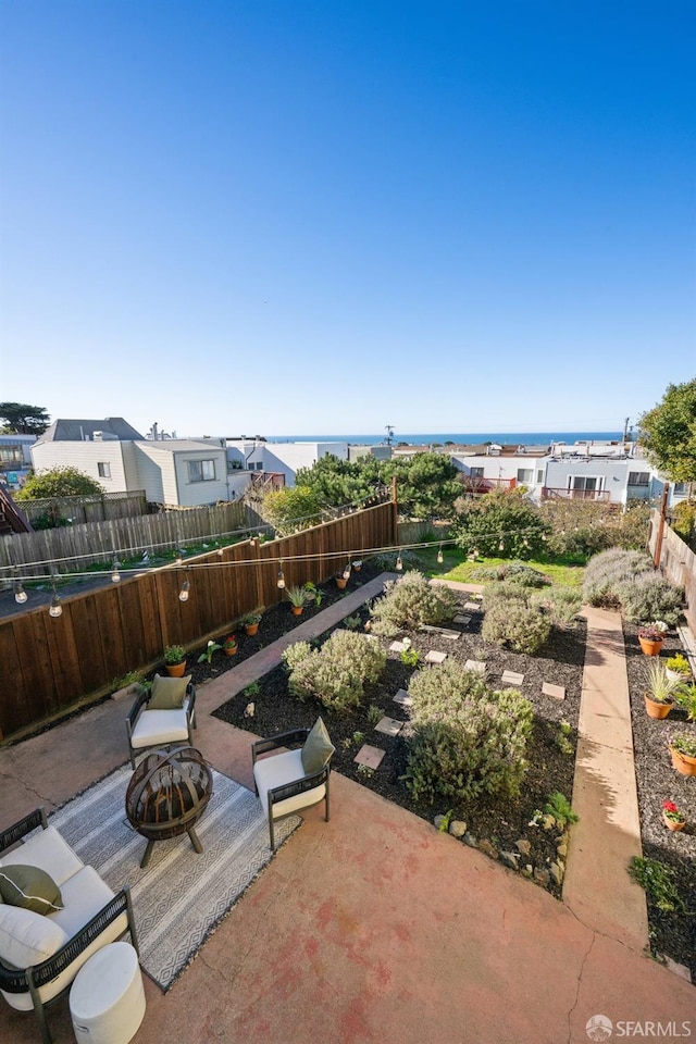 view of patio / terrace with a fire pit and a water view