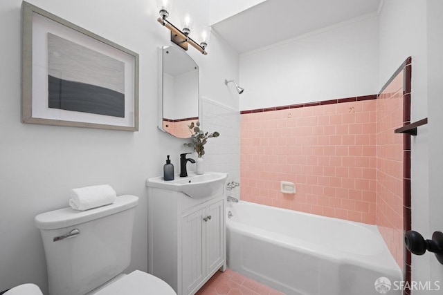 full bathroom featuring vanity, tiled shower / bath combo, and toilet