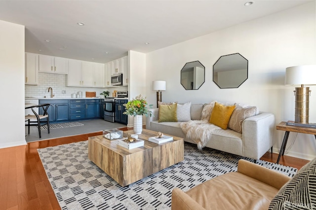 living room featuring light hardwood / wood-style flooring and sink