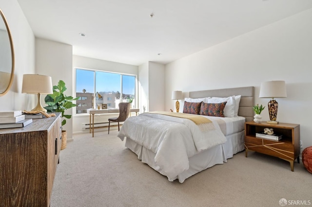 carpeted bedroom with a baseboard heating unit