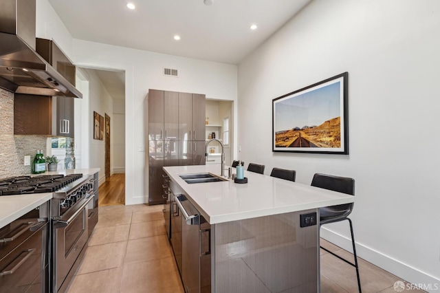 338 Scott St, San Francisco, CA 94117 - kitchen featuring wall chimney exhaust hood, stainless steel appliances, a sink, modern cabinets, and recessed lighting