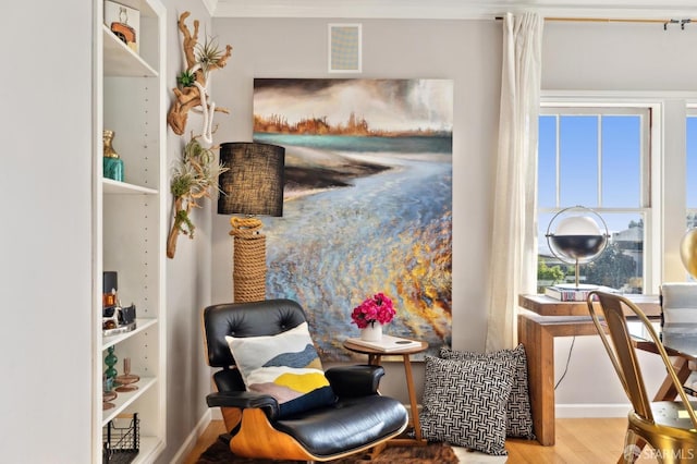 sitting room with visible vents and wood finished floors