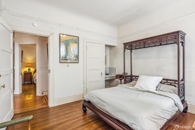 bedroom with dark hardwood / wood-style flooring