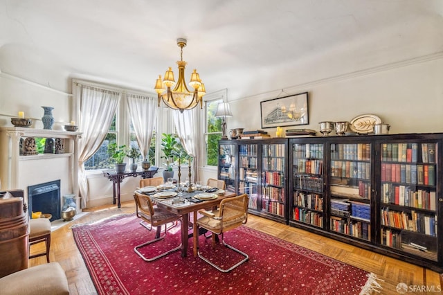 dining area with a chandelier and parquet floors