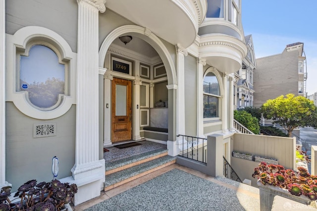 view of exterior entry with a porch