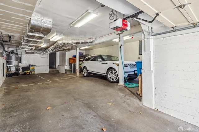 garage featuring a garage door opener, water heater, and a carport