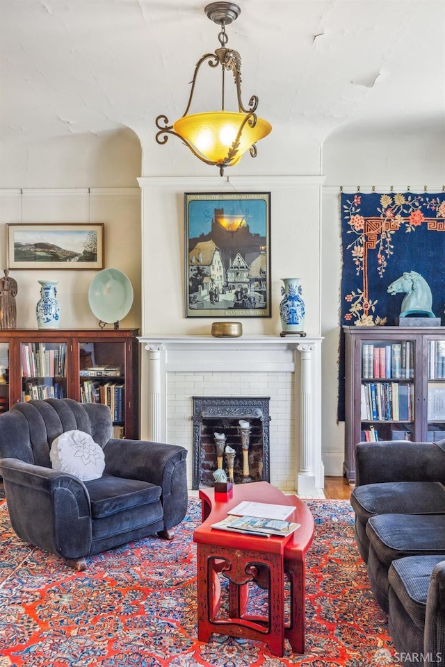 living room featuring wood-type flooring and a fireplace