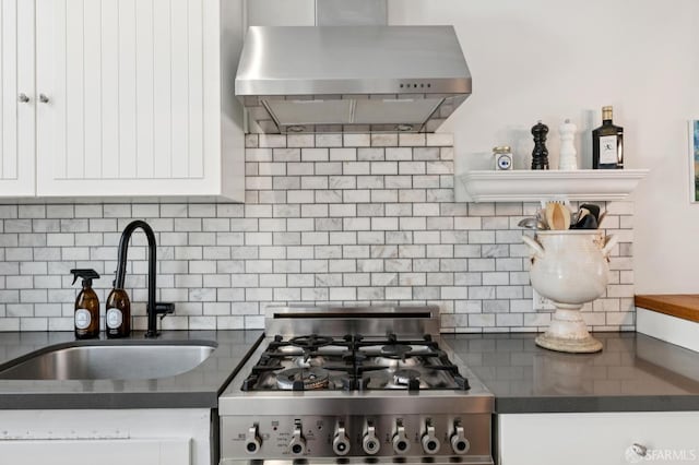 50 Perine Pl, San Francisco, CA 94115 - kitchen featuring range, wall chimney exhaust hood, a sink, and dark countertops